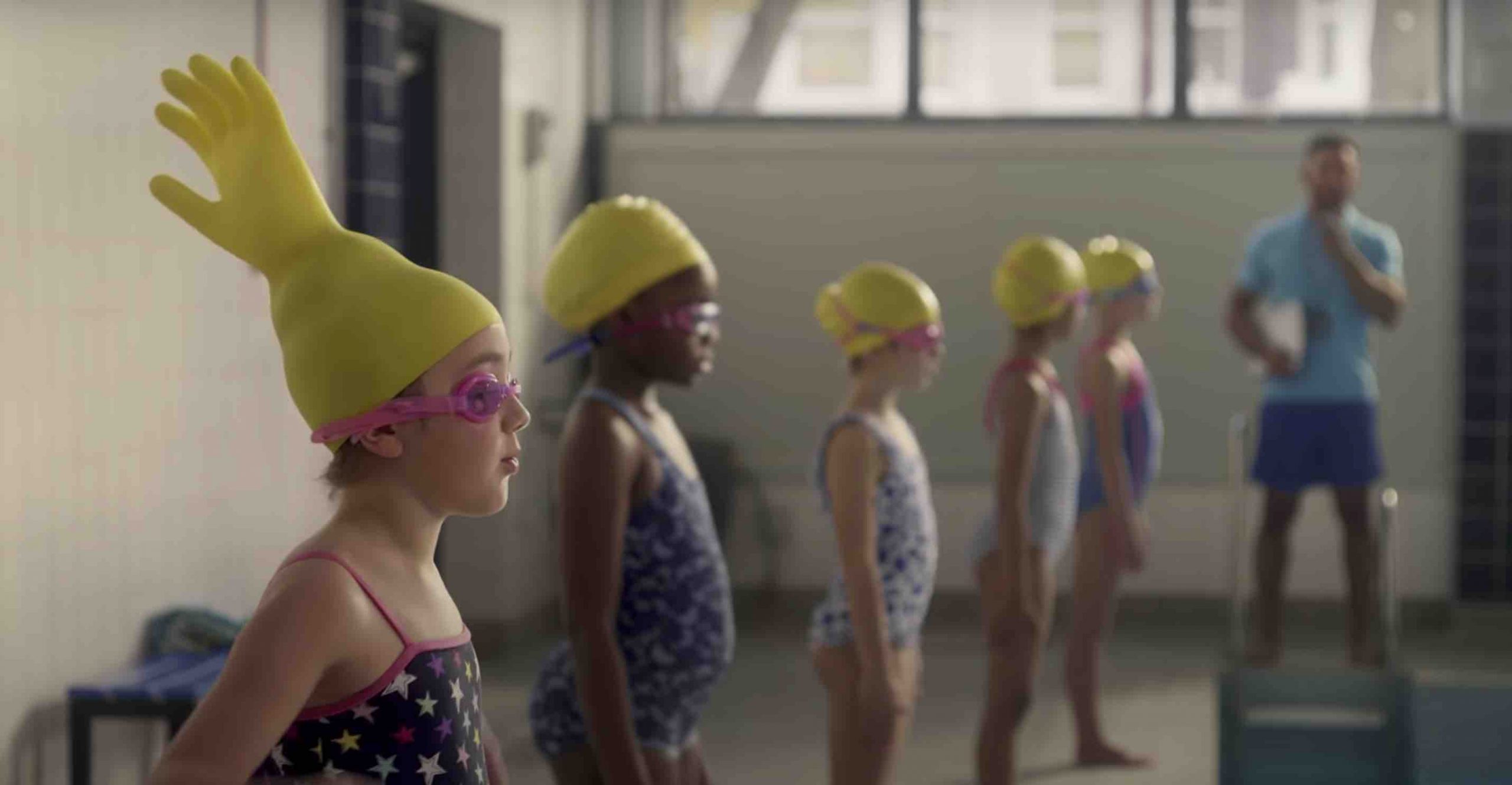 Swimming girl with rubber glove on her head from a funny McDonald's advert